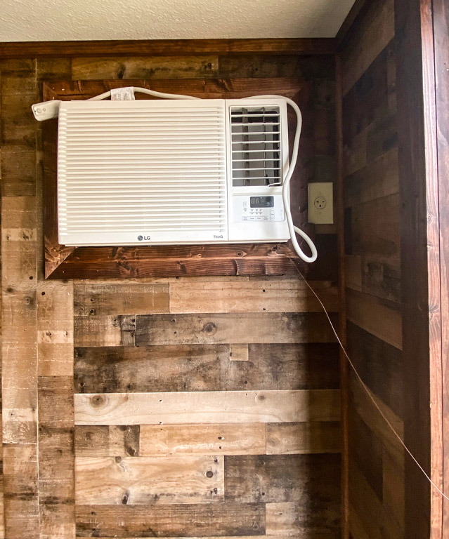 cabin with wood paneling and air conditioning